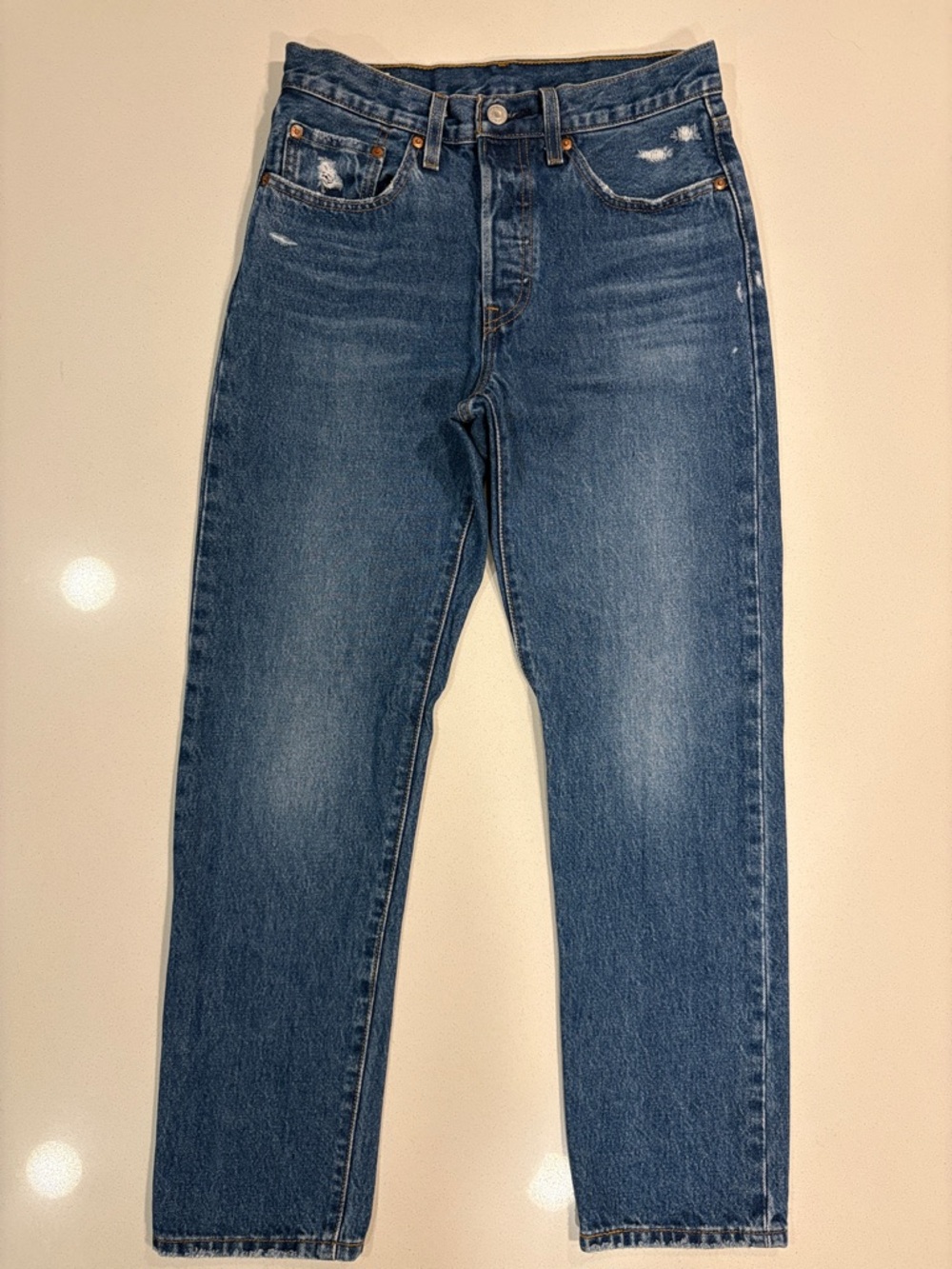 Levi's 501 Original Fit Women's Jeans in a distressed medium wash blue denim.